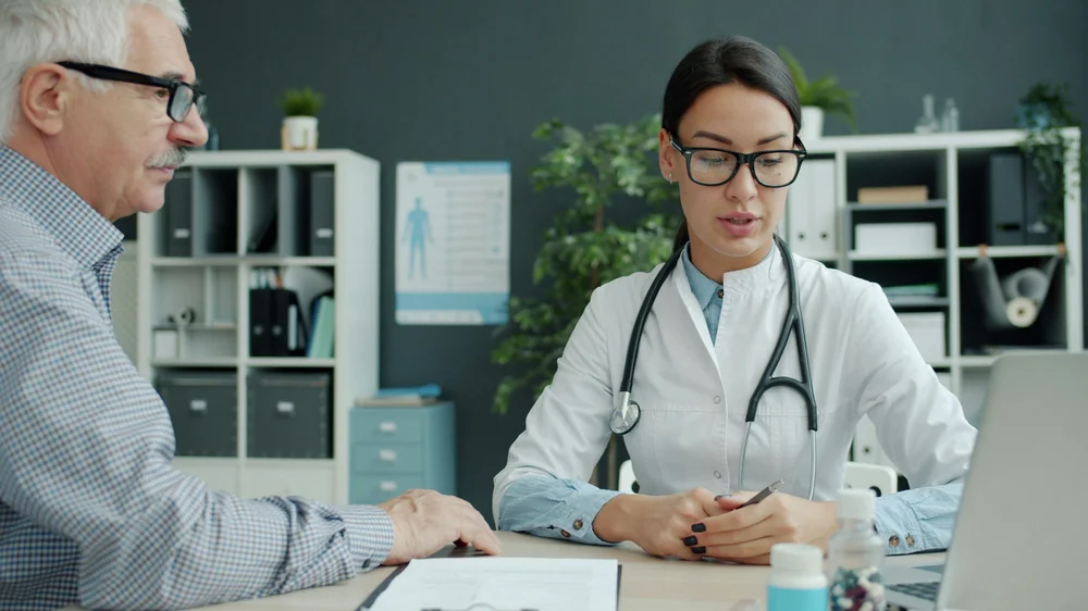 Provider evaluating a patient's facial muscle movement before a neuromodulator treatment